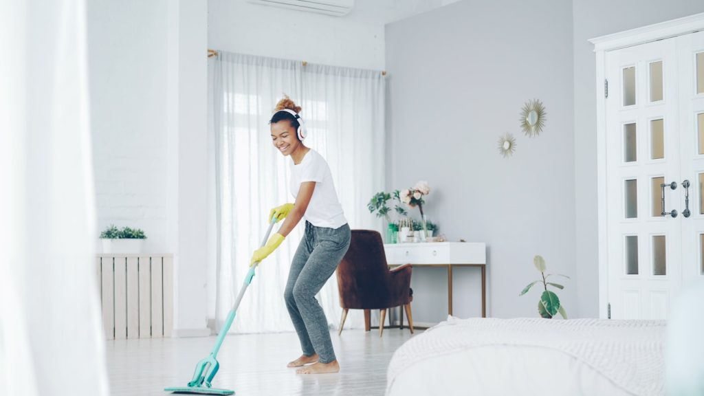 Cleaner mopping a bright residential room